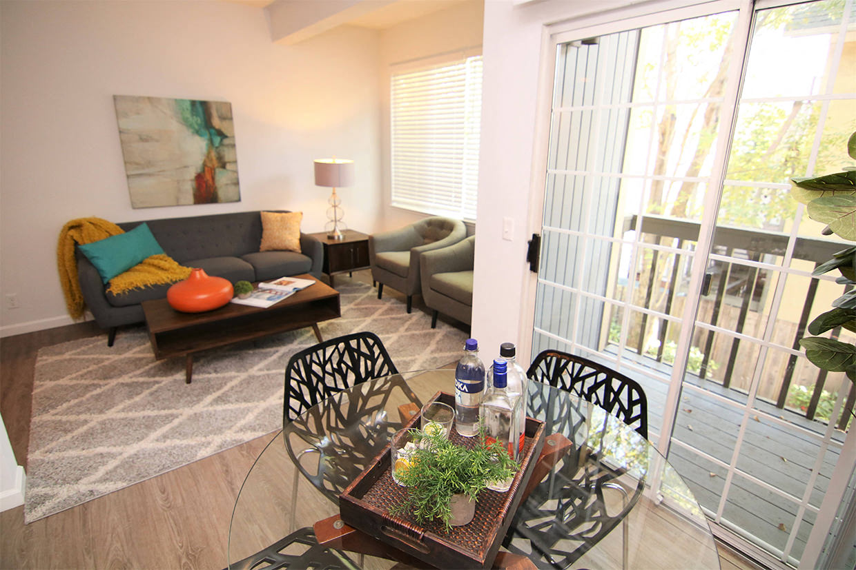 View of dining room, balcony, and living room